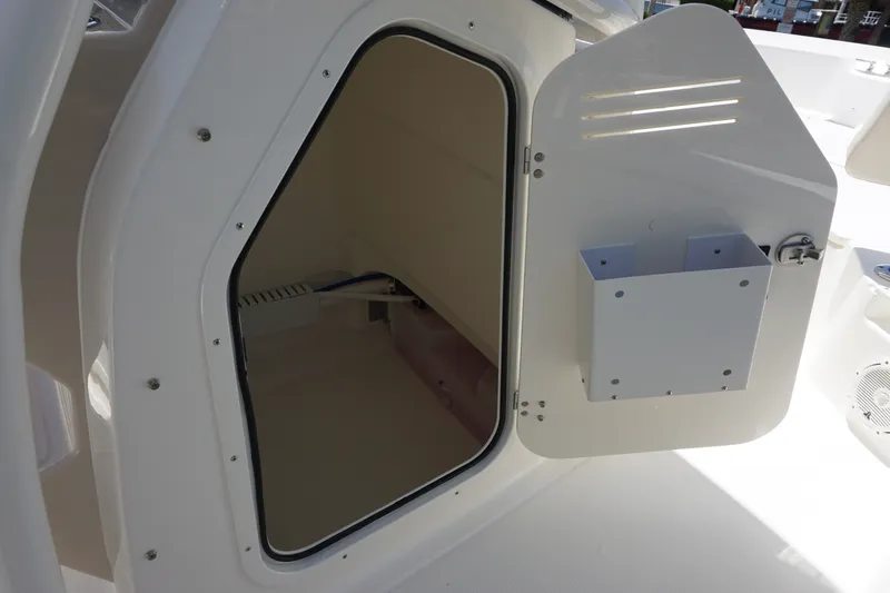 Slide: The Image of Storage compartment on a 2027 Boston Whaler 210 Montauk boat, open door view. - 34