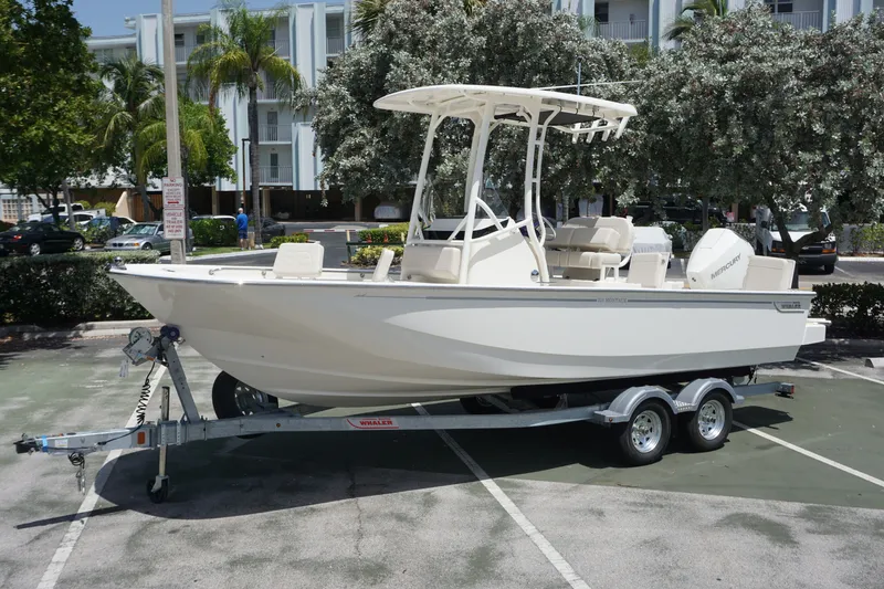 The Image of 2027 Boston Whaler 210 Montauk boat on trailer in a parking lot. - 0