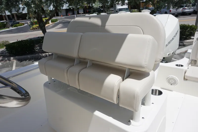Slide: The Image of Boston Whaler 210 Montauk 2027 boat seating with white upholstery and stainless steel accents. - 17