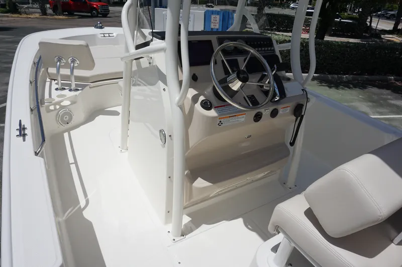 Slide: The Image of 2027 Boston Whaler 210 Montauk boat interior with steering console and seating. - 25