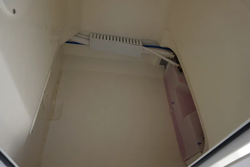 Slide: The Image of Interior compartment of a 2027 Boston Whaler 210 Montauk boat, showing wiring and storage space. - 35