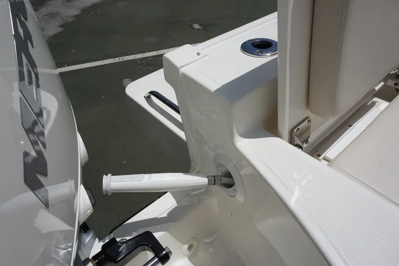 Slide: The Image of 2027 Boston Whaler 210 Montauk boat detail, featuring sleek white seating and engine components. - 15