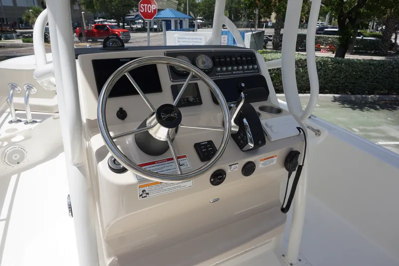 Slide: The Image of Steering console of 2027 Boston Whaler 210 Montauk boat with controls and gauges. - 21