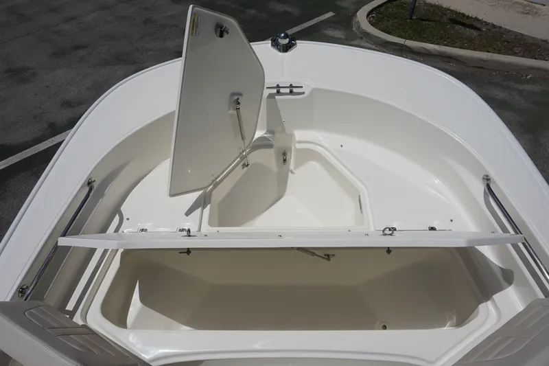 Slide: The Image of 2027 Boston Whaler 210 Montauk boat storage compartments open, showcasing spacious interior design. - 31
