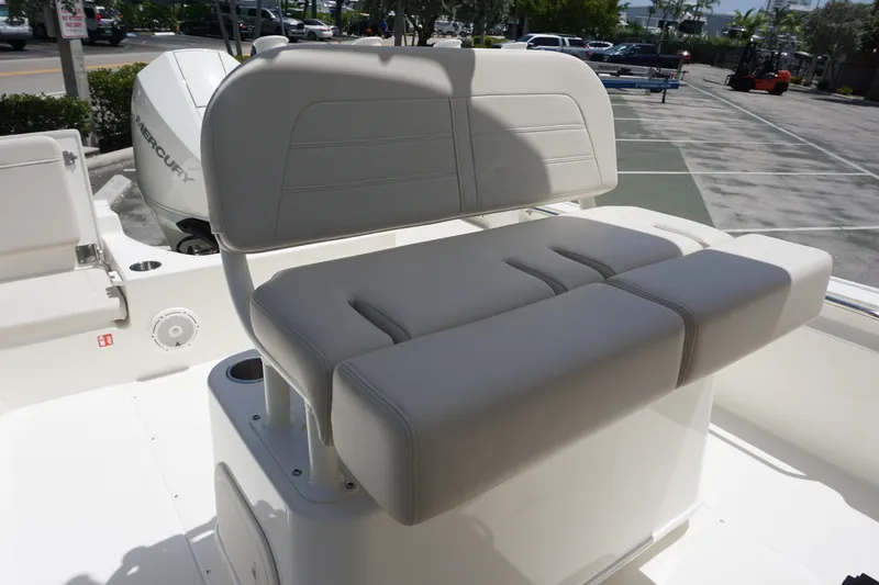 Slide: The Image of 2027 Boston Whaler 210 Montauk boat seat with Mercury engine in background. - 19