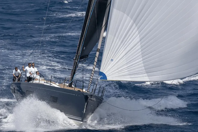 Slide: The Image of Manufacturer Provided Image: Sailing the ocean, 2026 Beneteau First 53 yacht with crew, cutting through waves. - 2