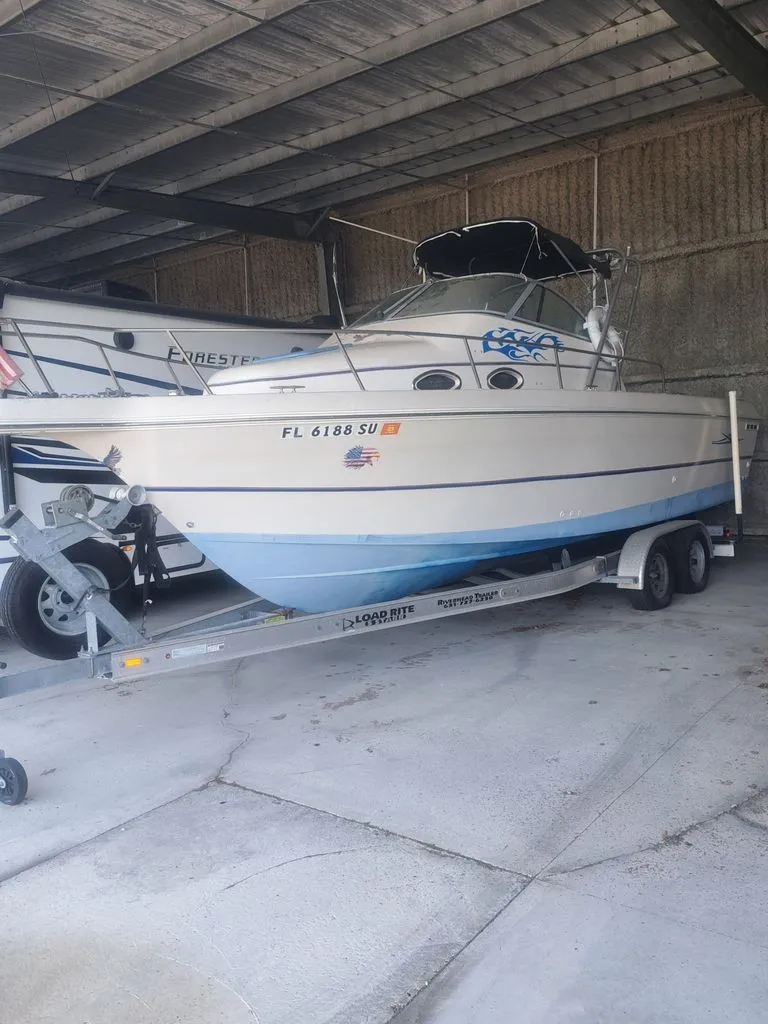 The Image of A 1997 Pro-Line 2700 Sportsman on a trailer in a covered area. - 0