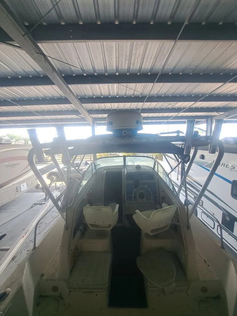 Slide: The Image of The image shows the cockpit of a 1997 Pro-Line 2700 Sportsman under a covered area. - 2