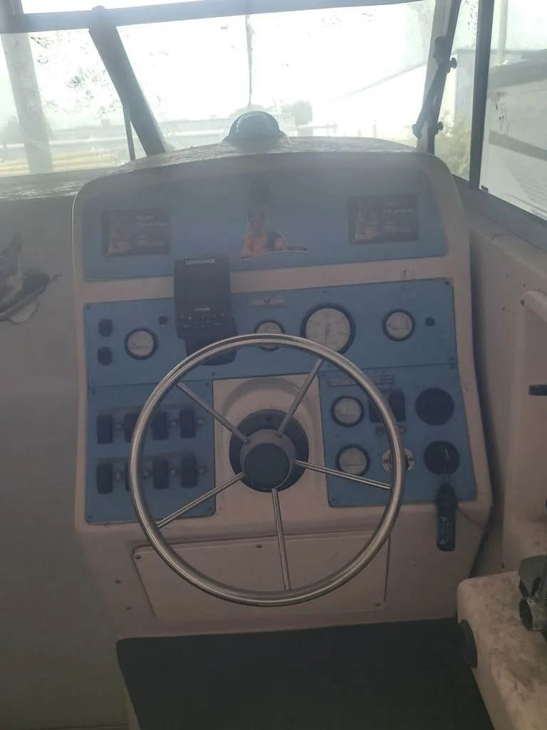 Slide: The Image of The image shows the helm of a 1997 Pro-Line 2700 Sportsman with blue and white controls. - 3
