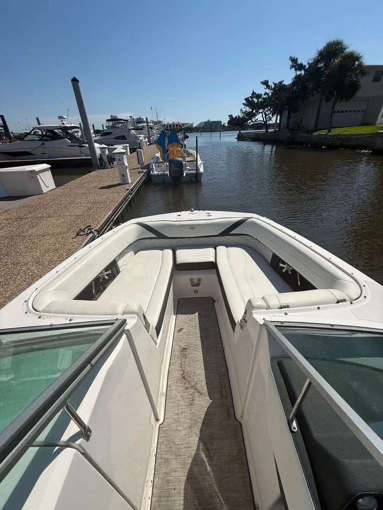 Slide: The Image of The image shows the bow of a 2018 Regal 26 FasDeck boat with white seating. - 4