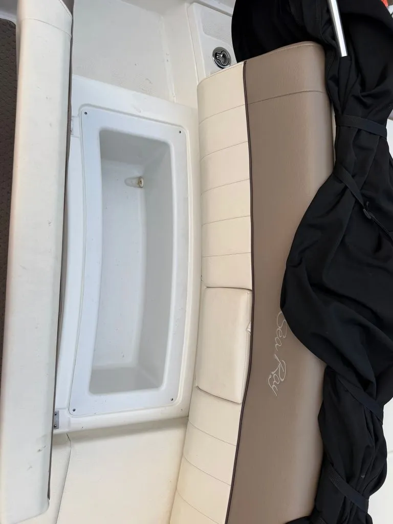 Slide: The Image of A seating area on a Sea Ray 210 SLX boat with beige and white upholstery. - 10
