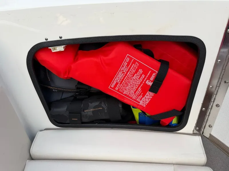 Slide: The Image of A storage compartment on a boat with red life jackets and other gear. - 9