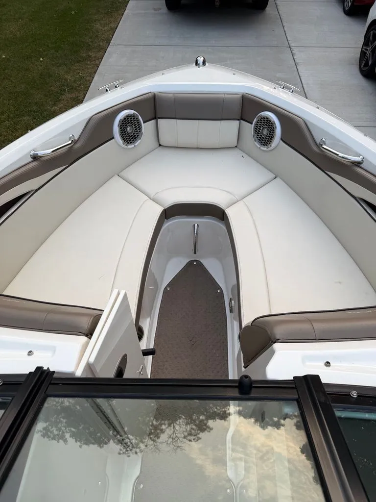 Slide: The Image of The image shows the bow of a 2013 Sea Ray 210 SLX boat with cushioned seating and speakers. - 3