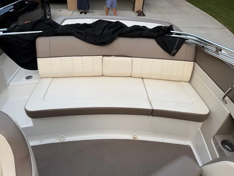 Slide: The Image of The image shows the rear seating of a 2013 Sea Ray 210 SLX boat with beige upholstery. - 7