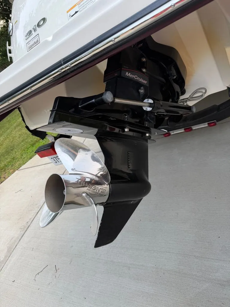 Slide: The Image of Close-up of a shiny propeller on a Sea Ray 210 SLX boat, resting on a trailer. - 23