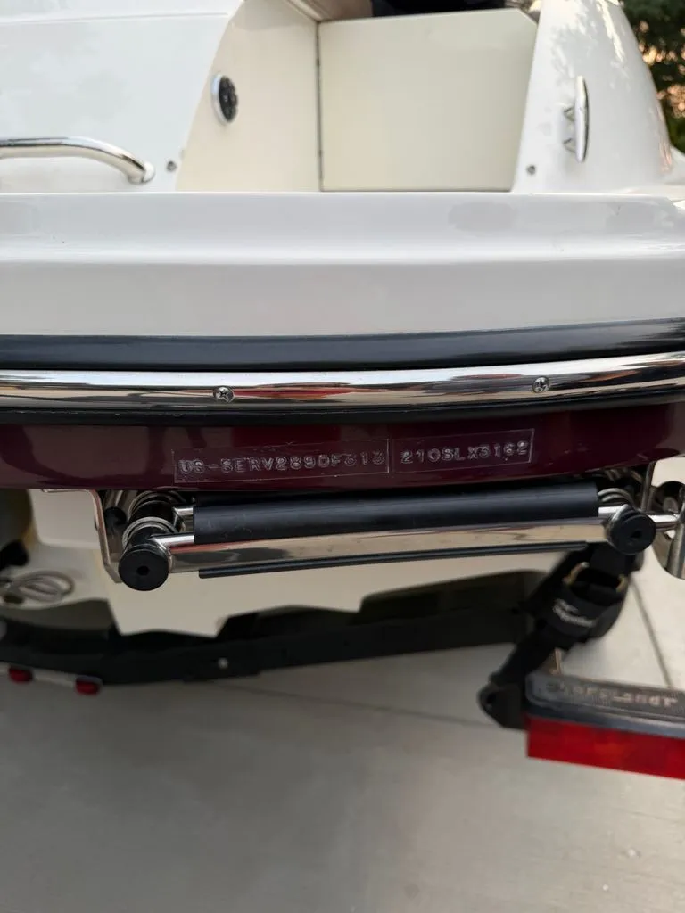 Slide: The Image of The image shows the stern of a 2013 Sea Ray 210 SLX boat with a serial number. - 20
