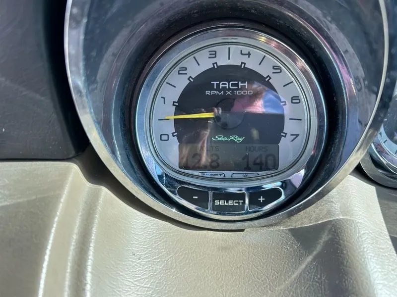 Slide: The Image of Close-up of a tachometer in a Sea Ray 260 Sundeck boat, displaying 128 hours. - 6