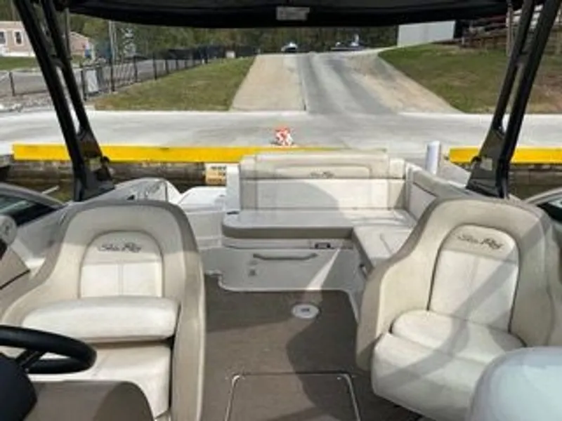 Slide: The Image of The image shows the cockpit of a 2013 Sea Ray 260 Sundeck boat with white seating. - 4