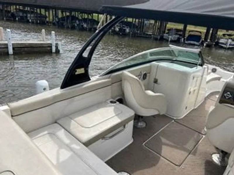 Slide: The Image of The image shows the cockpit of a 2013 Sea Ray 260 Sundeck boat with beige seating. - 7