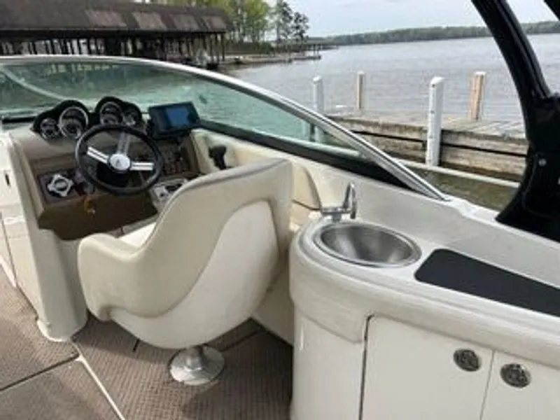 Slide: The Image of The image shows the cockpit of a 2013 Sea Ray 260 Sundeck boat with a helm and sink. - 5