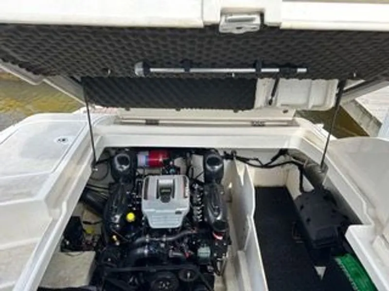 Slide: The Image of The engine compartment of a 2013 Sea Ray 260 Sundeck with an open lid, showing the engine and wiring. - 9