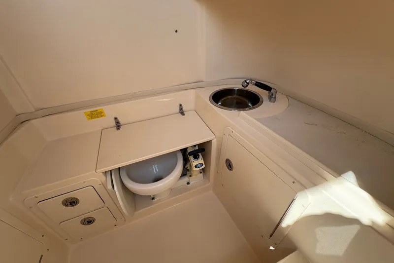 Slide: The Image of 2011 Grady-White Canyon 283 boat interior with sink and concealed toilet. - 15