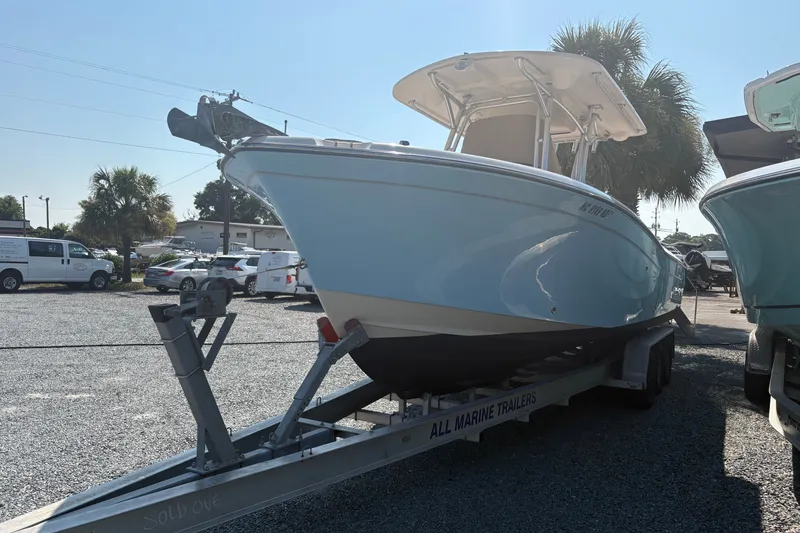 Slide: The Image of 2011 Grady-White Canyon 283 boat on trailer in sunny outdoor setting. - 3