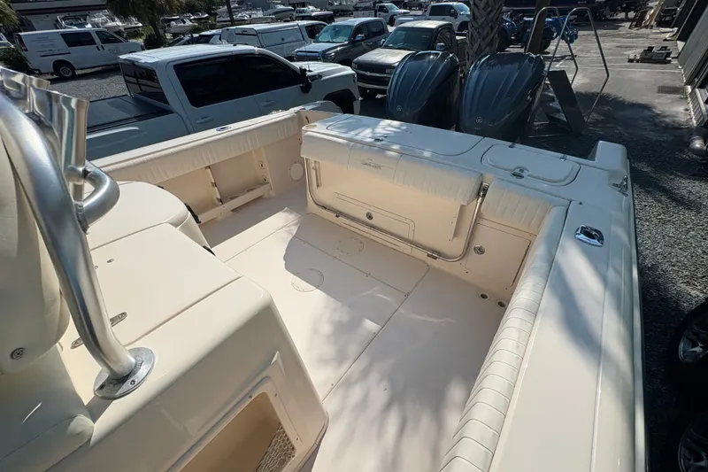 Slide: The Image of 2011 Grady-White Canyon 283 boat interior, featuring spacious seating and storage areas. - 21