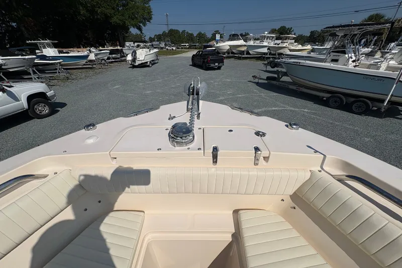Slide: The Image of 2011 Grady-White Canyon 283 boat interior with seating, parked among other boats. - 5