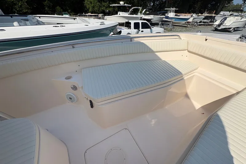 Slide: The Image of 2011 Grady-White Canyon 283 boat interior with cushioned seating and storage. - 7