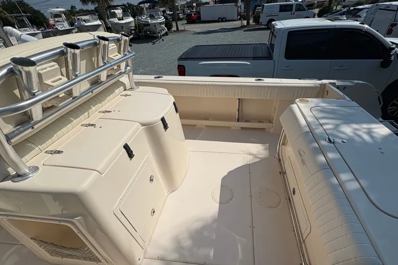 Slide: The Image of The image shows the spacious cockpit of a 2011 Grady-White Canyon 283 with storage and seating. - 22