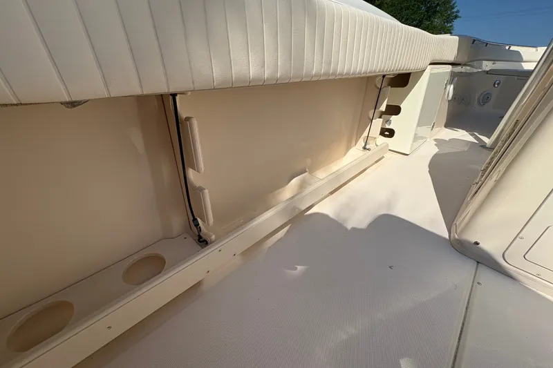 Slide: The Image of 2011 Grady-White Canyon 283 boat interior with cushioned seating and cup holders. - 27