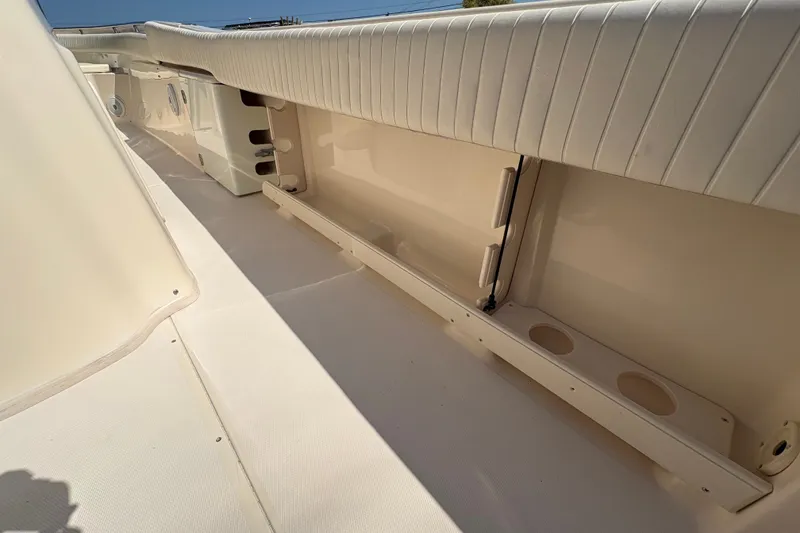 Slide: The Image of 2011 Grady-White Canyon 283 boat interior with cushioned seating and storage compartments. - 26
