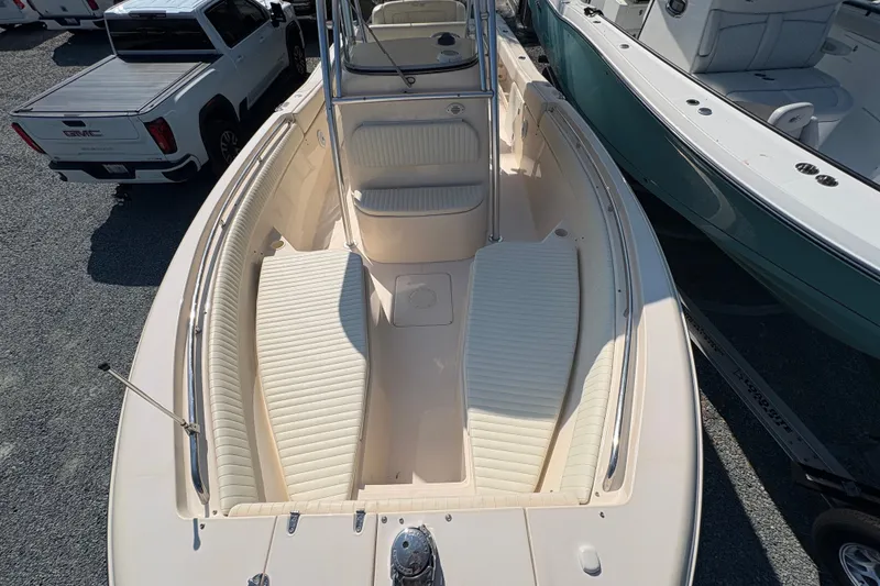 Slide: The Image of The image shows a 2011 Grady-White Canyon 283 boat. It features a spacious bow with cushioned seating areas and a central helm. - 4