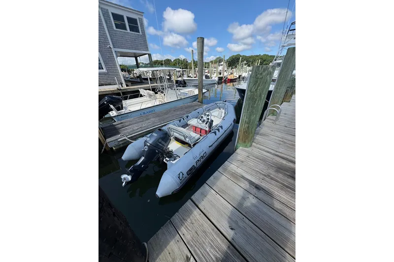 Slide: The Image of 2015 Zodiac Bayrunner 500 docked at a marina, under a clear blue sky. - 1