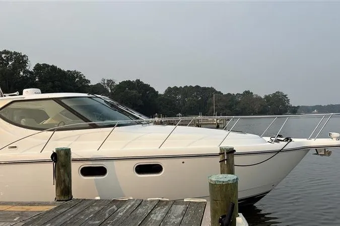 Slide: The Image of 2007 Tiara 3900 Sovran yacht docked by a serene waterfront. - 8