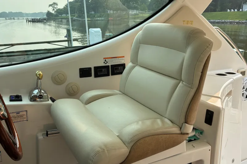 Slide: The Image of Captain's chair in 2007 Tiara 3900 Sovran yacht cockpit, overlooking serene waterfront. - 38