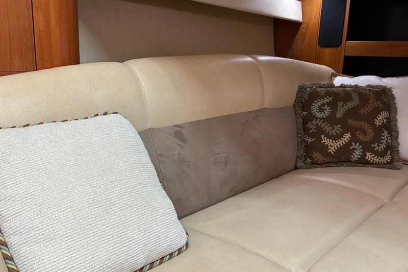 Slide: The Image of Luxurious beige seating with decorative pillows in a 2007 Tiara 3900 Sovran yacht interior. - 54
