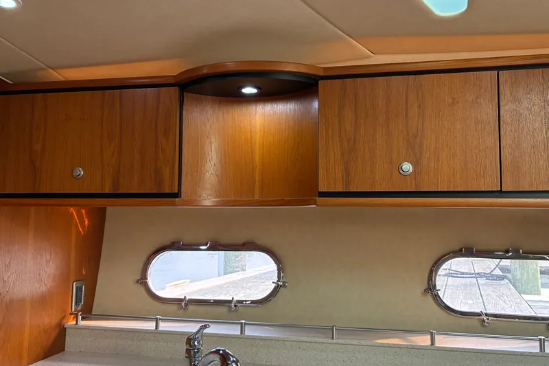 Slide: The Image of Interior of 2007 Tiara 3900 Sovran yacht with wooden cabinets and porthole windows. - 47