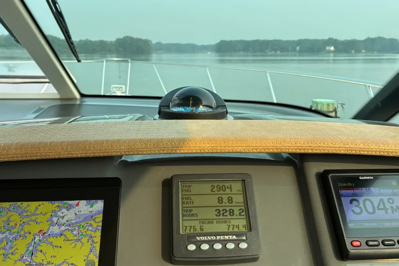 Slide: The Image of Cockpit view of 2007 Tiara 3900 Sovran yacht with navigation instruments and serene waterway. - 34