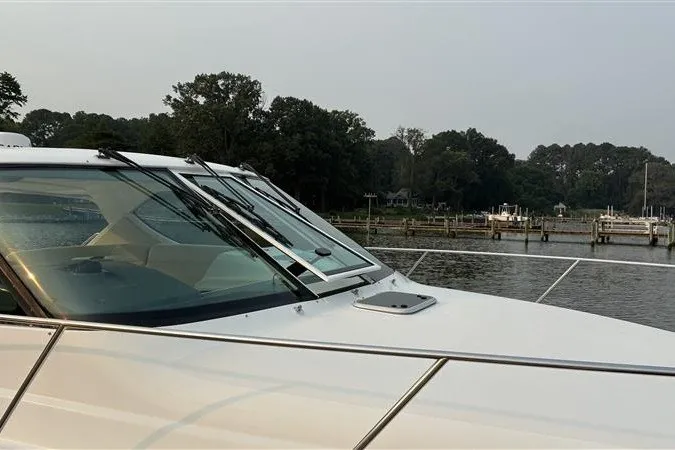 Slide: The Image of 2007 Tiara 3900 Sovran yacht docked by a serene waterfront. - 12