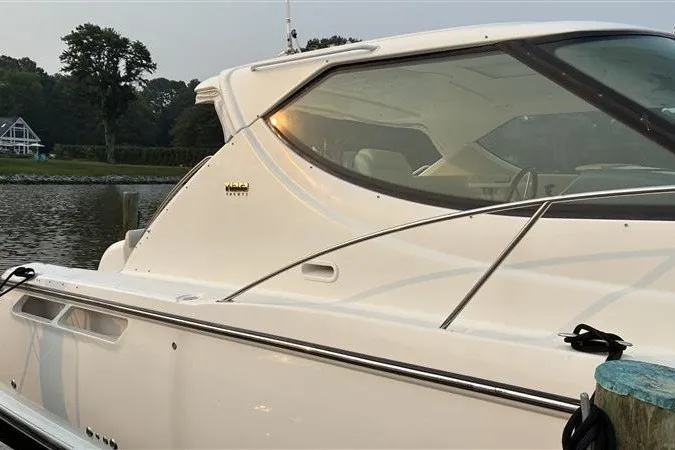 Slide: The Image of 2007 Tiara 3900 Sovran yacht docked by a serene waterfront. - 9