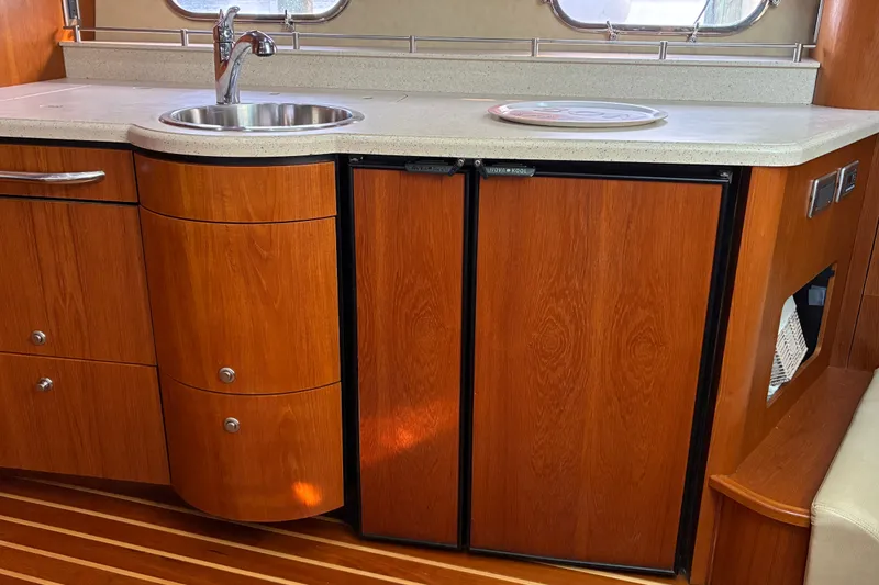 Slide: The Image of 2007 Tiara 3900 Sovran yacht interior with wooden cabinetry and compact kitchenette. - 48