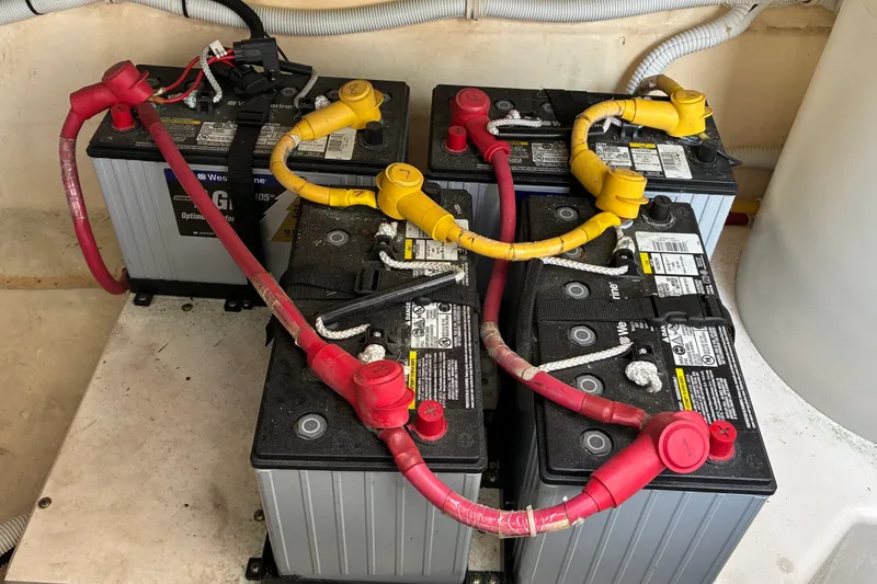 Slide: The Image of Four marine batteries with red and yellow cables in a 2007 Tiara 3900 Sovran. - 65