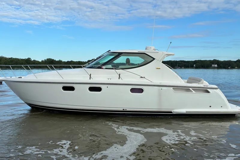 Slide: The Image of 2007 Tiara 3900 Sovran yacht on calm water under a clear blue sky. - 3