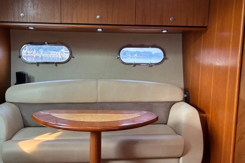 Slide: The Image of Interior of 2007 Tiara 3900 Sovran yacht with cozy seating and wooden table. - 53