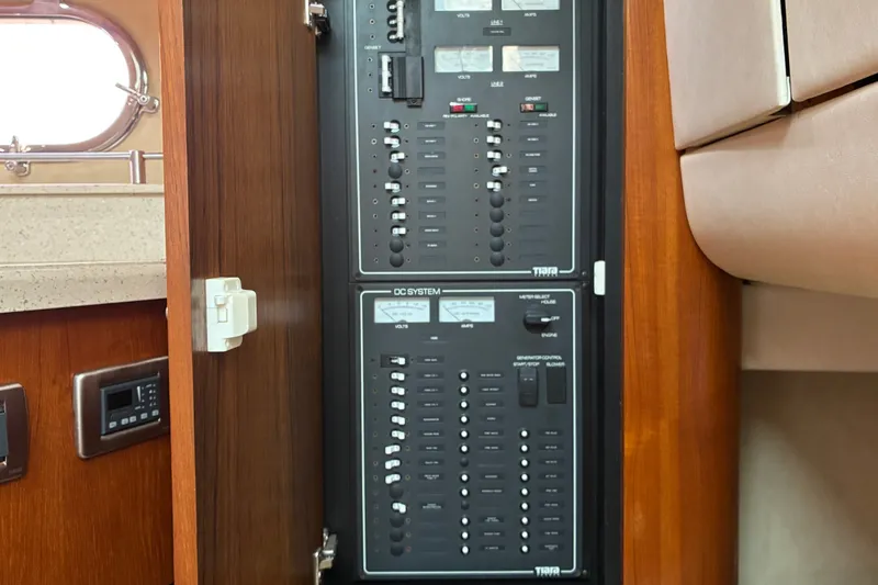 Slide: The Image of Electrical panel inside 2007 Tiara 3900 Sovran yacht, featuring control switches and gauges. - 58