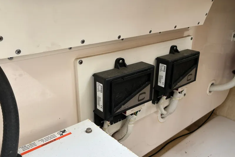 Slide: The Image of Electrical components inside a 2007 Tiara 3900 Sovran boat, featuring wiring and control boxes. - 68