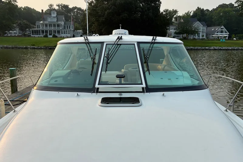 Slide: The Image of 2007 Tiara 3900 Sovran yacht docked by waterfront homes. - 16