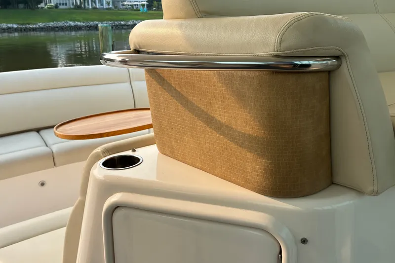Slide: The Image of Luxury seating on a 2007 Tiara 3900 Sovran yacht with cup holder and wooden table. - 28